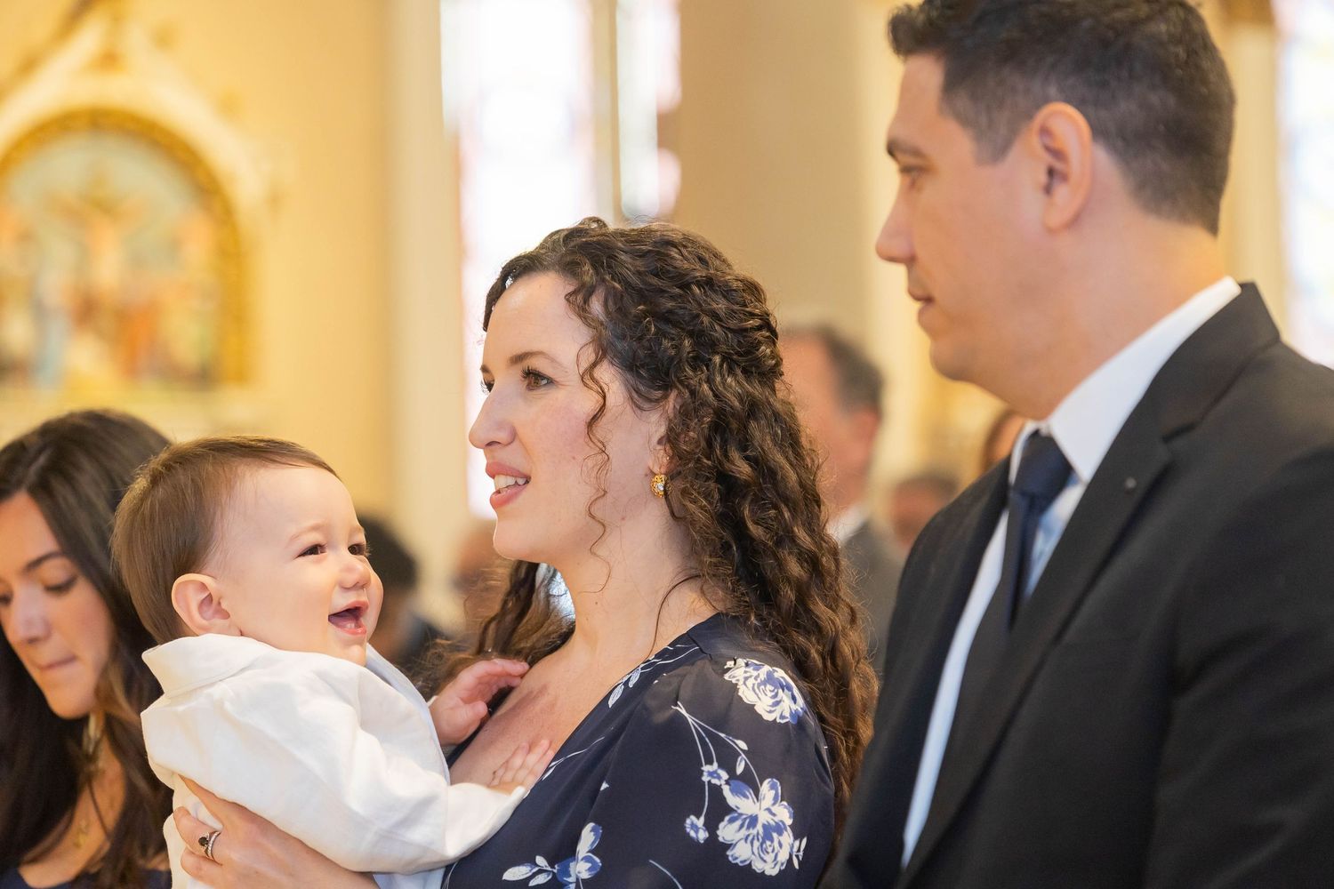 Candid moment during church baptism ceremony with joyful expressions.