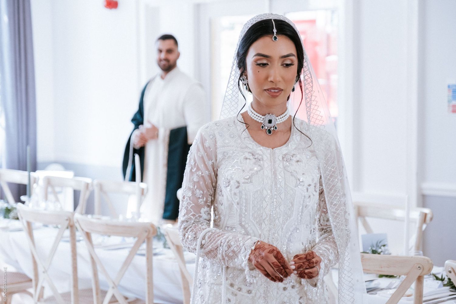 Muslim bride and grooms standing around a table at the London wedding venue