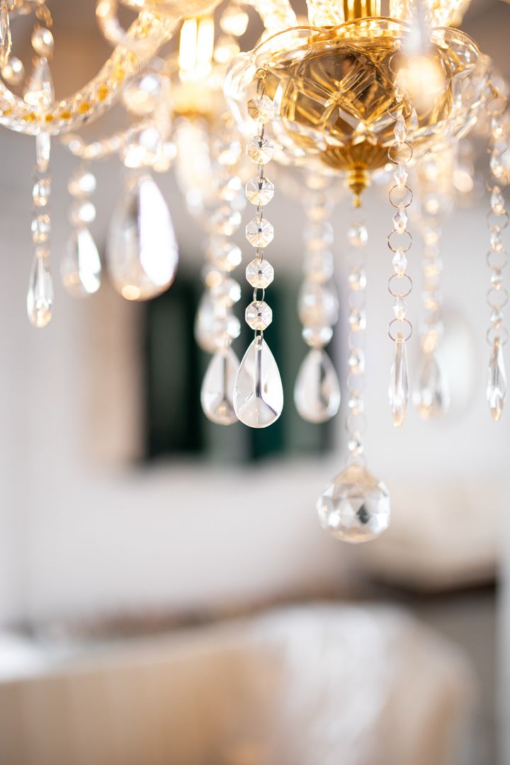Crystal chandelier with hanging teardrop prisms captured in soft focus.