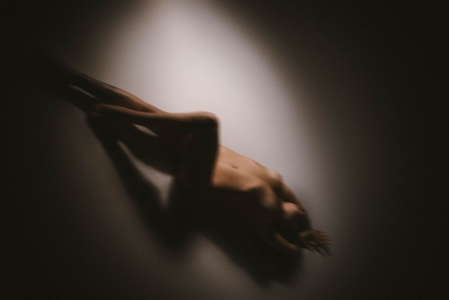 Abstract blurred dark silhouette creating a moody atmospheric composition.