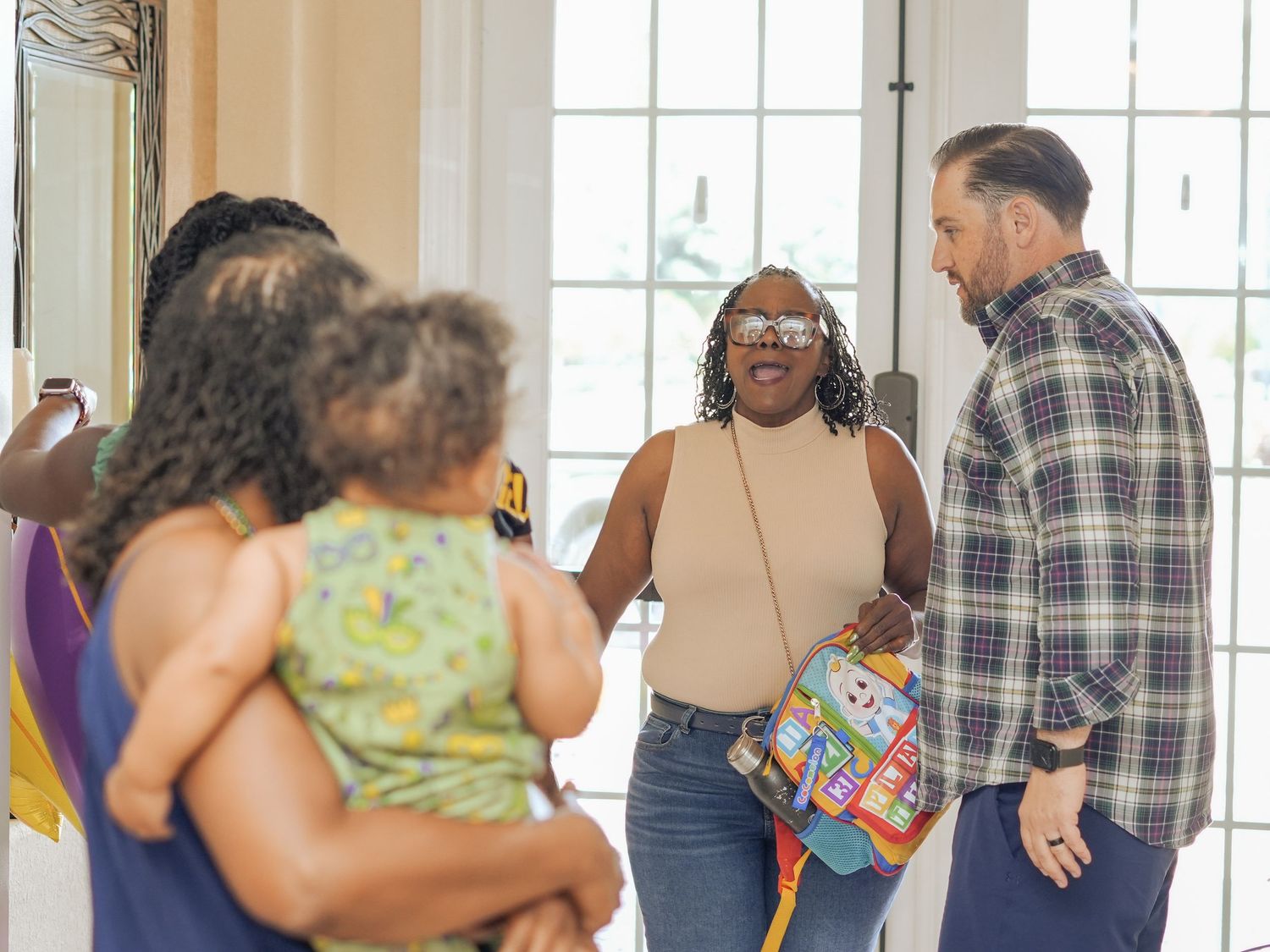 Guests mingling and socializing at an indoor celebration event.