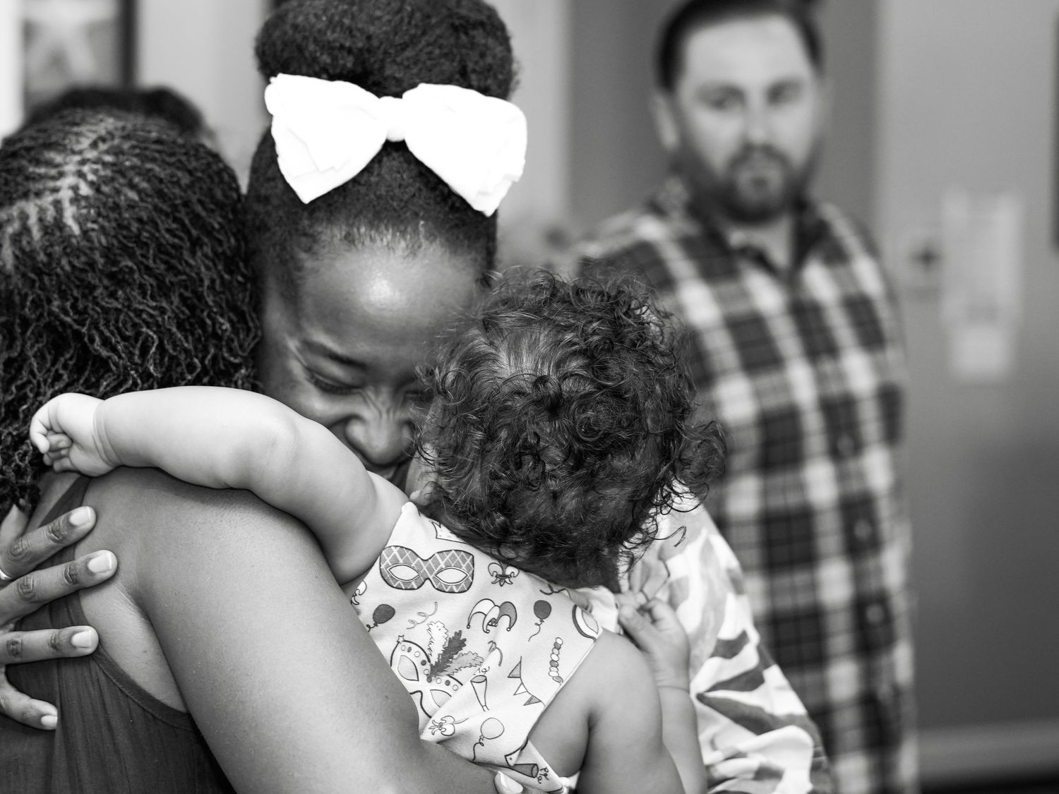 Intimate moment captured in black and white at a family celebration.