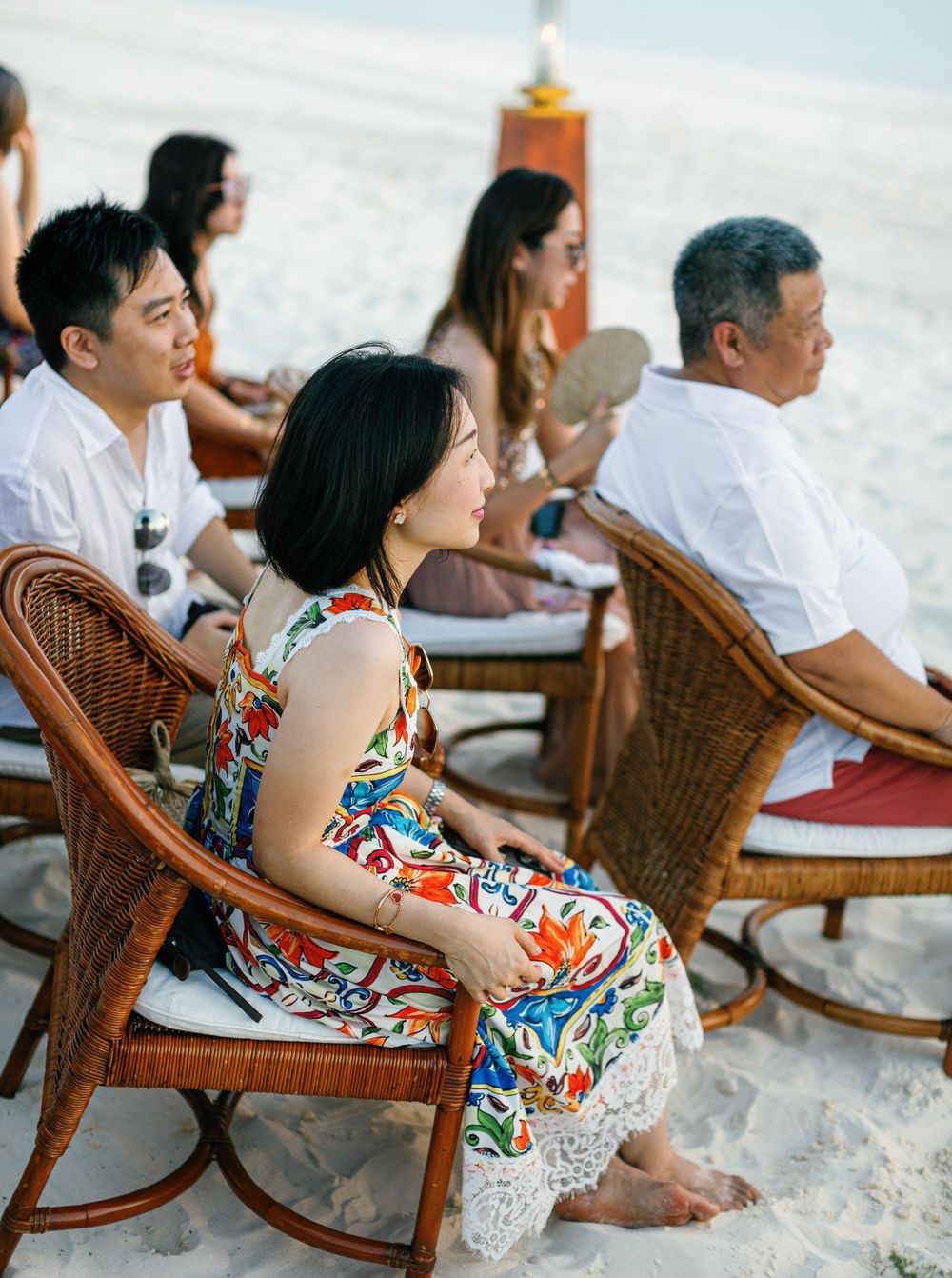 Wedding guests at beach ceremony at Aman resort in Amanpulo, Philippines.
