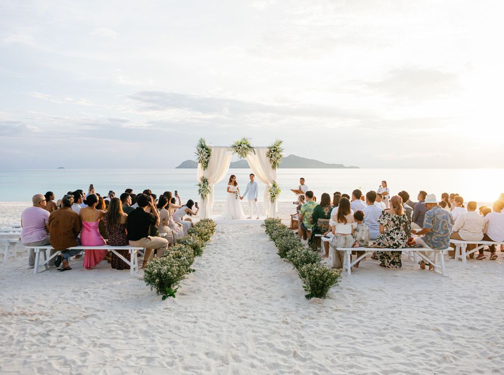 A professional photographer captures a wedding ceremony on the beach of Aman resort in Amanpulo, Philippines.