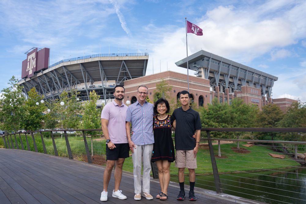 Family near Kyle Field celebrating together in College Station's vibrant atmosphere.