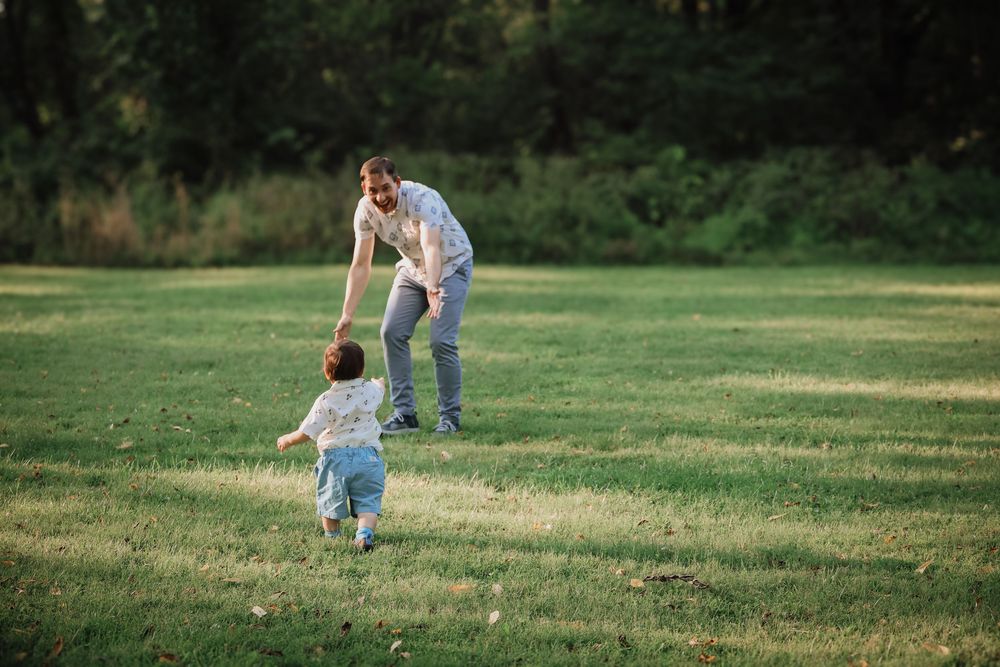 People play together in a grassy field on a bright sunny day.