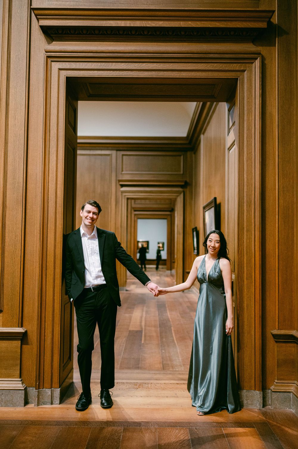 Artistic dance poses captured in wood-paneled hallway showing movement and grace.