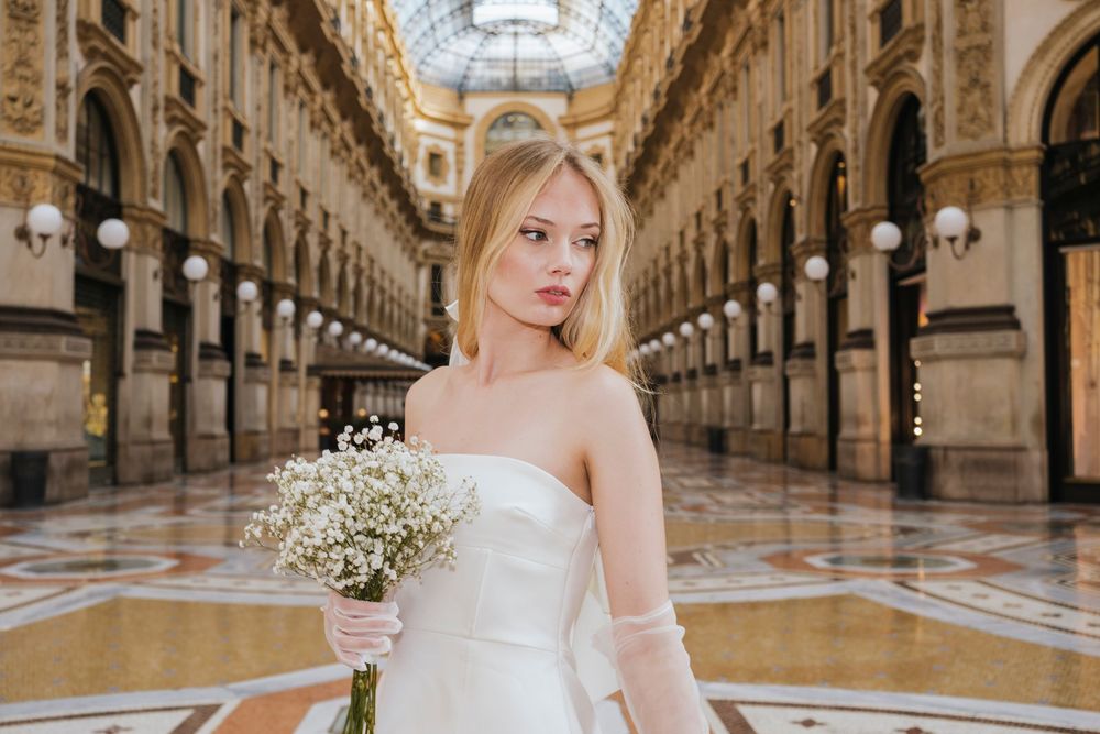 Beautiful bridal portraits in the ornate Galleria Vittorio Emanuele II shopping arcade in Milan with elegant arches and decor.