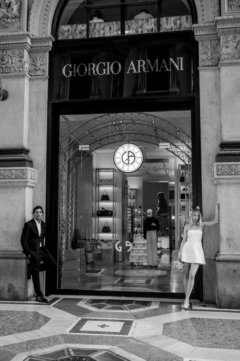 Giorgio Armani storefront entrance in a luxury shopping arcade with ornate architectural details and doorways.