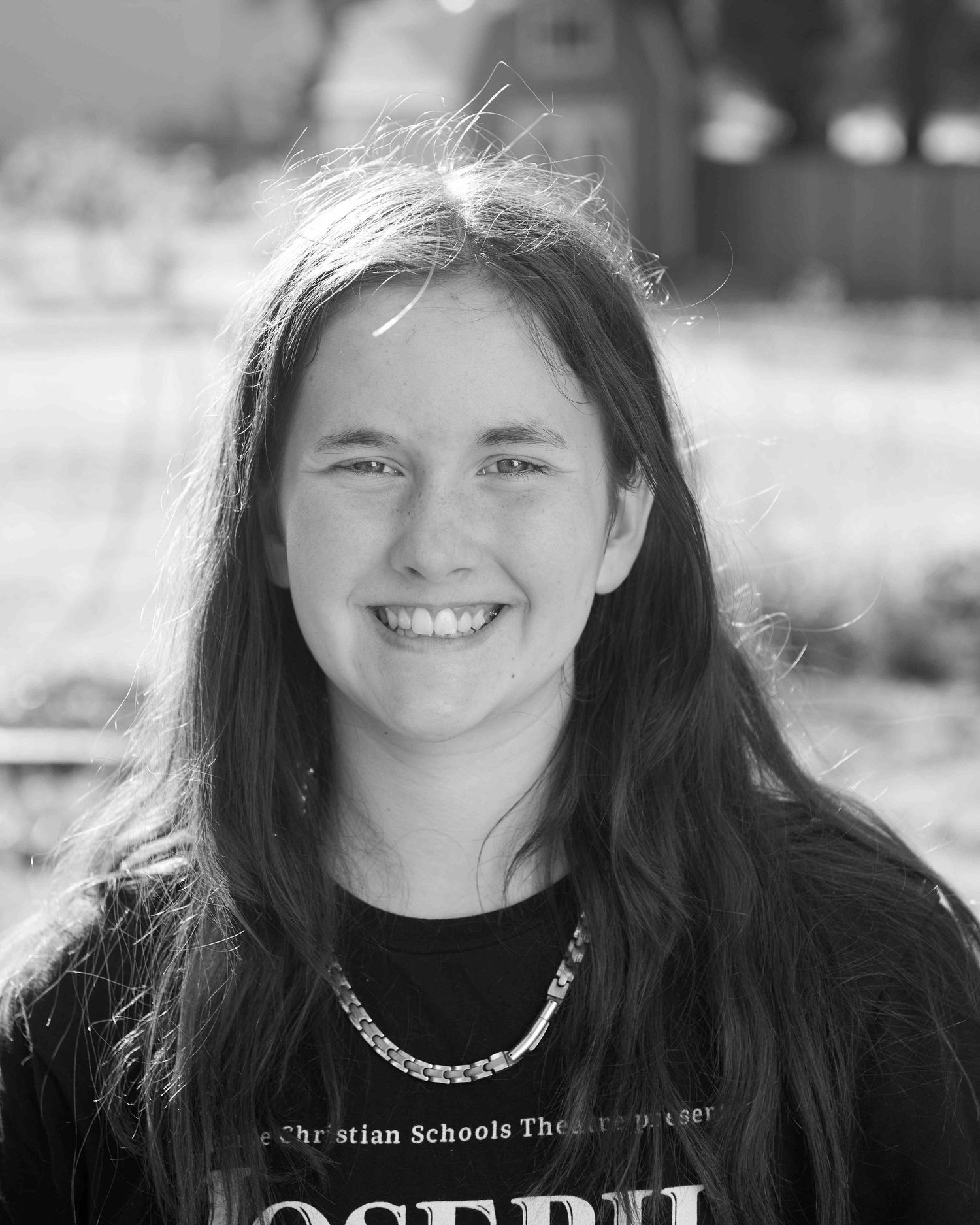 black and white headshot of junior high girl outside in natural light