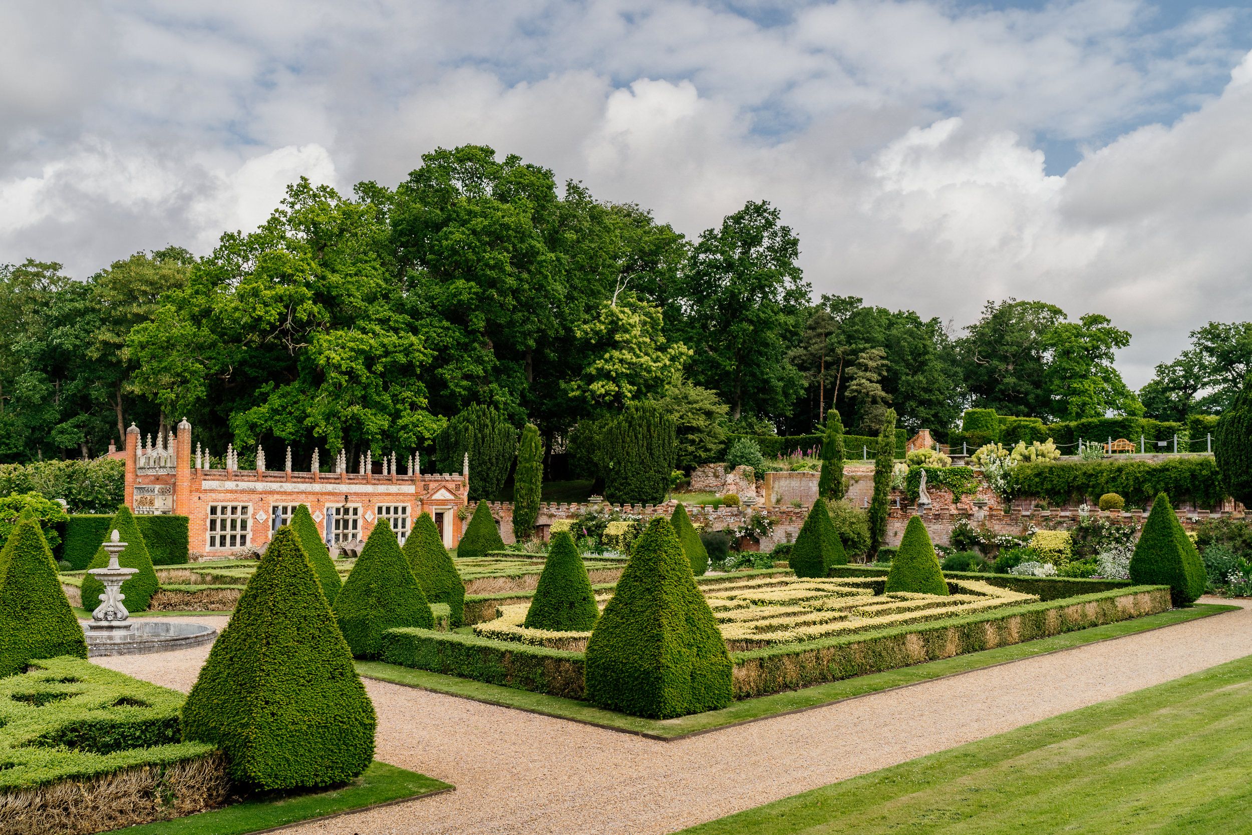 Formal garden at Oxnead Hall with perfectly manicured topiary hedges and geometric patterns at a historic estate.