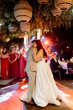 A romantic dance sequence at an outdoor wedding reception with paper lanterns hanging from trees above the dance floor.