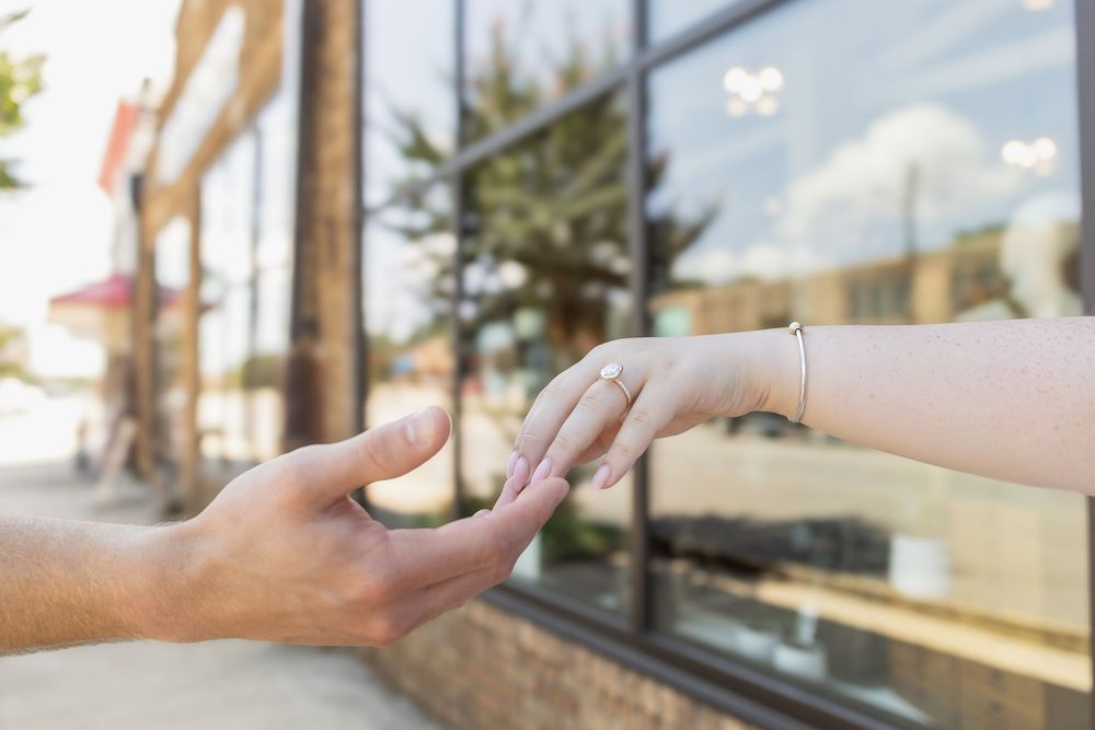 Series of hands reaching out against a bright window background.
