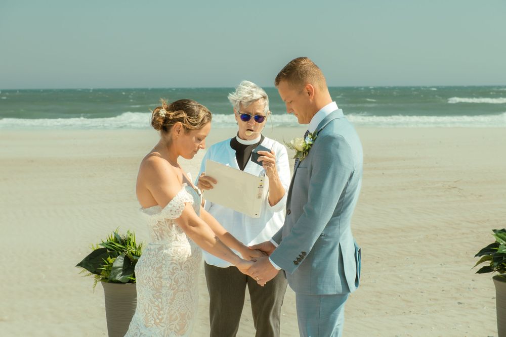 Intimate beach wedding ceremony with couple exchanging vows by the ocean.
