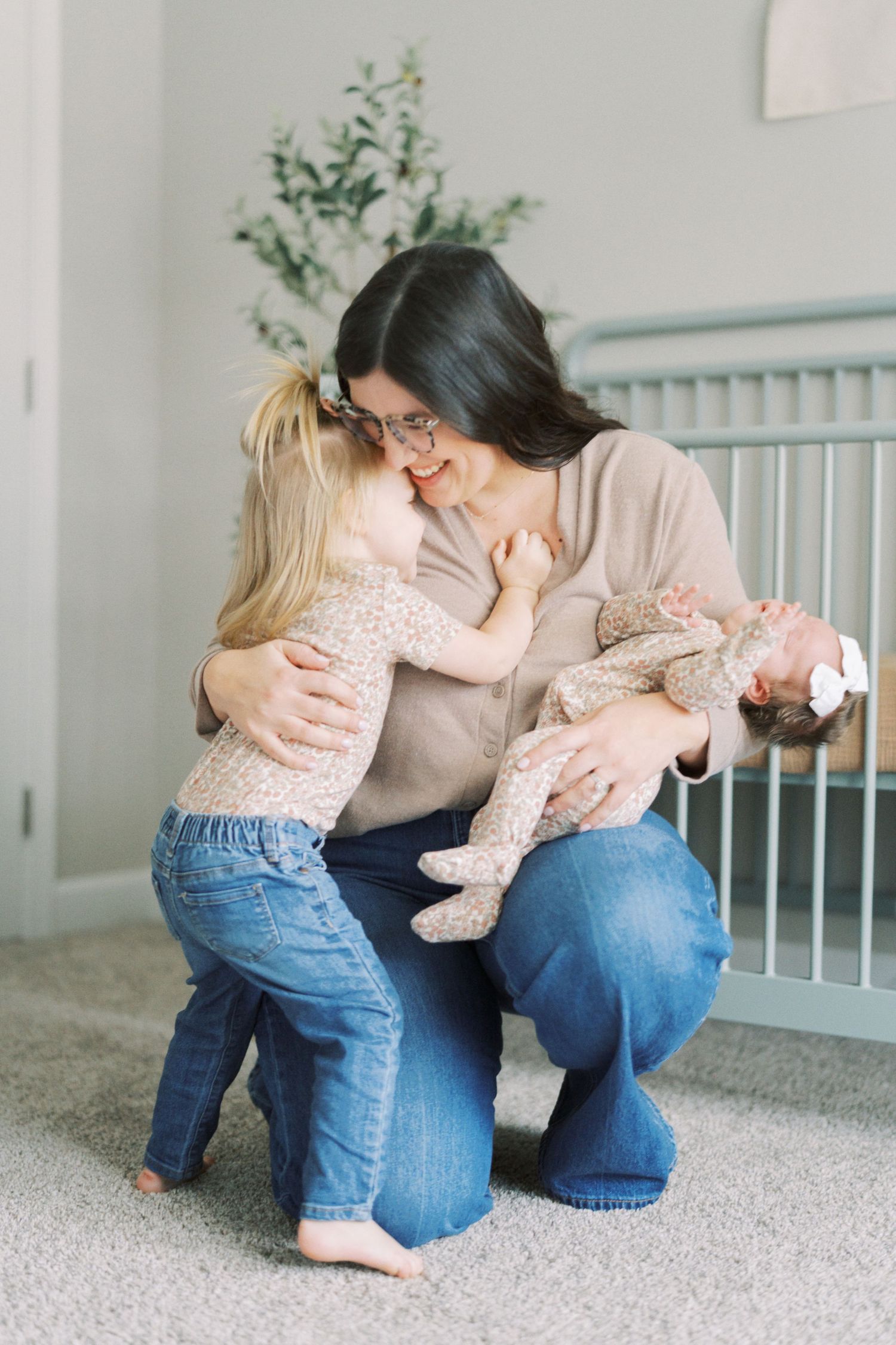 A tender series of moments showing parents cuddling with a small child on a carpeted floor indoors.