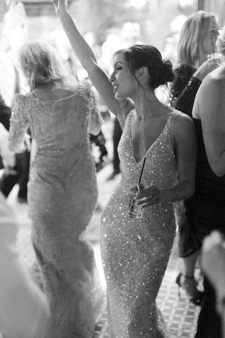 bride sparkling formal gown dances with their arm raised on a crowded dance floor, elegant wedding. Bowery Hotel Wedding, New york wedding