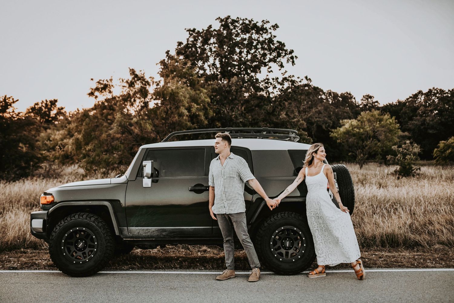 Couple embracing under soft golden light during their Texas engagement shoot