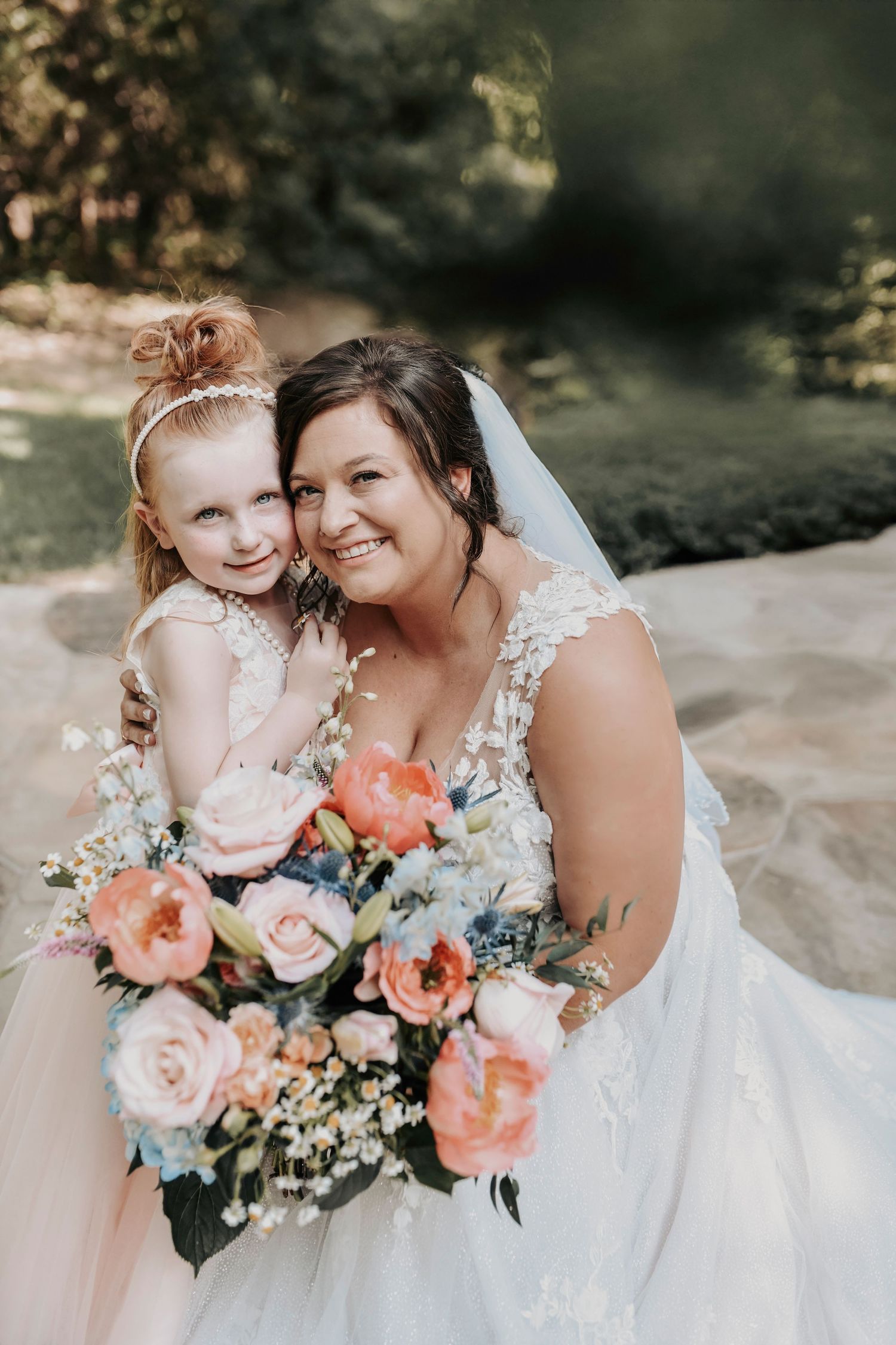 Tender moment of bride hugging her daughter before the ceremony