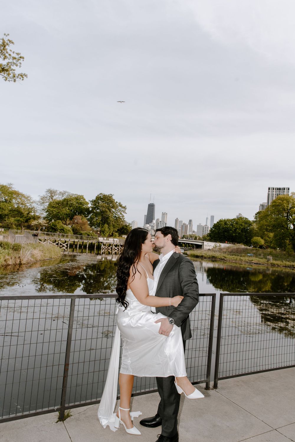 Romantic elegance captured along Lincoln Park South Pond walkway with Chicago skyline in the background.