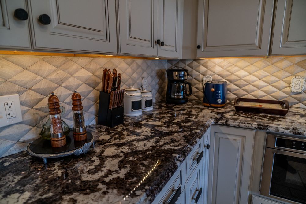 Kitchen counter featuring salt and pepper grinders, knives, coffee machine, and toaster, creating a functional cooking space.