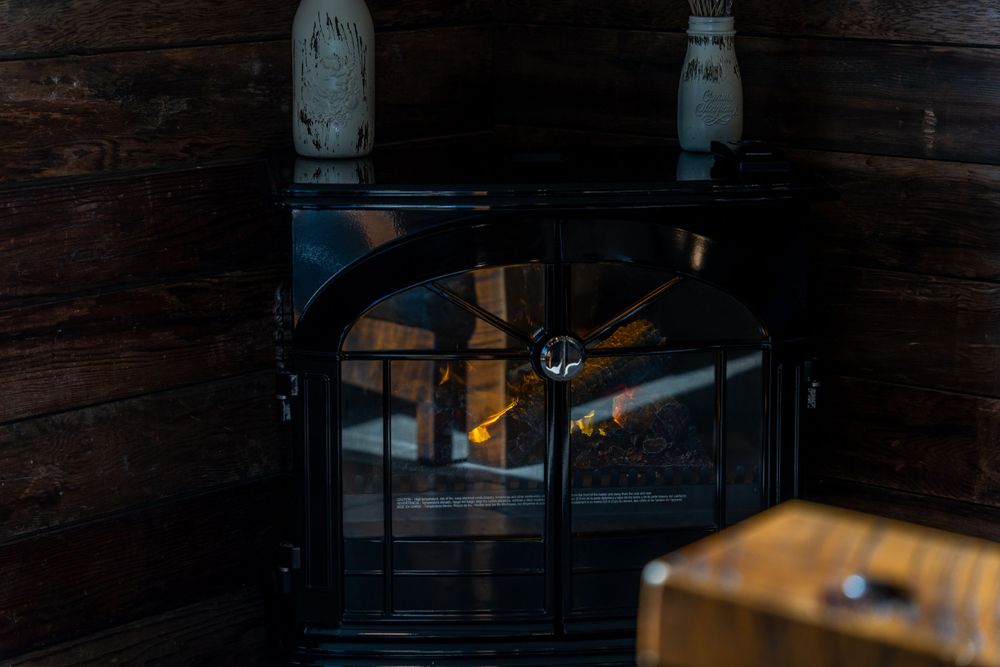 Close-up of electric fireplace, showcasing glowing flames and modern design in a cozy living space.