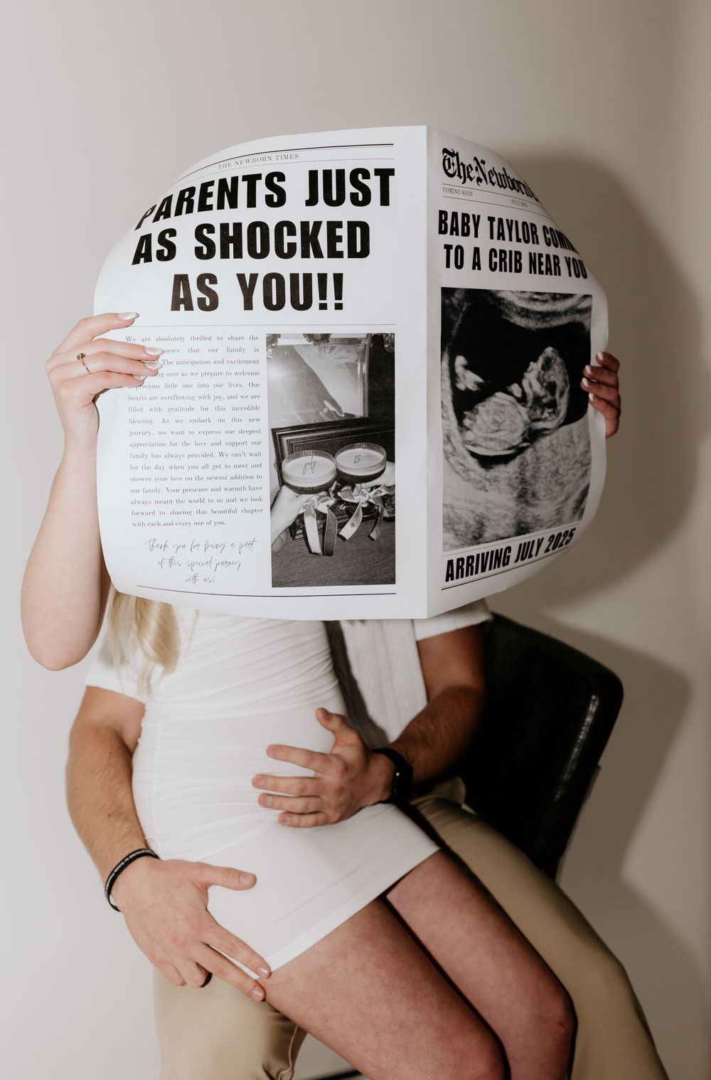 A creative pregnancy announcement with newspaper-style headlines and ultrasound photos.