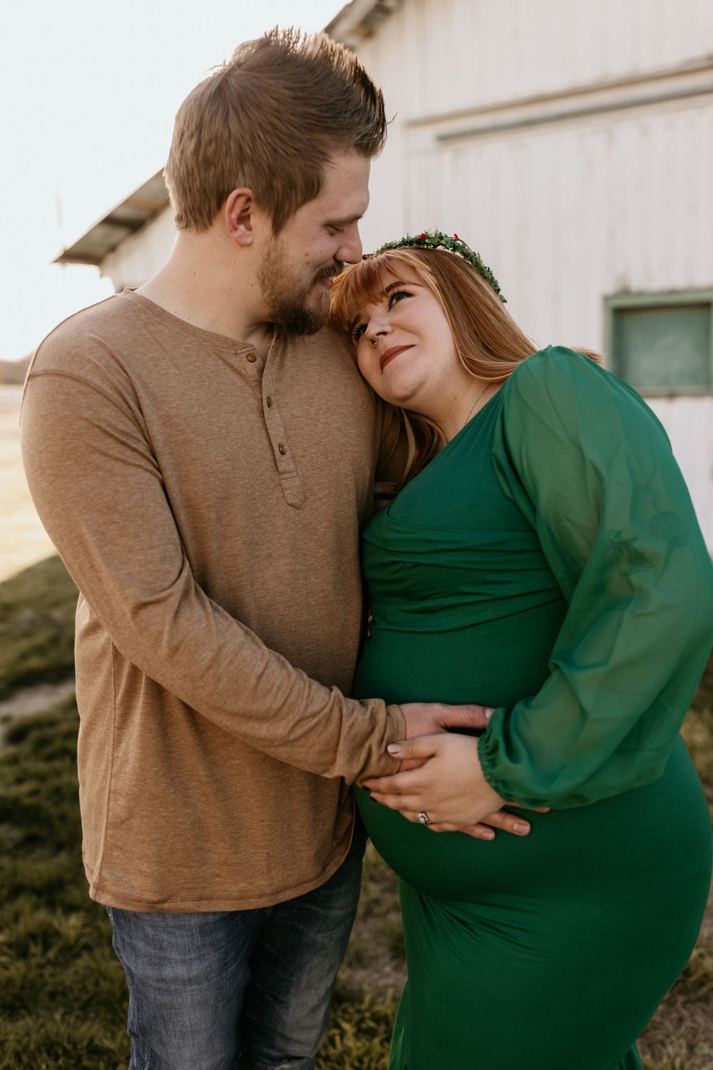 Intimate moment between couple in casual wear outside rustic building.