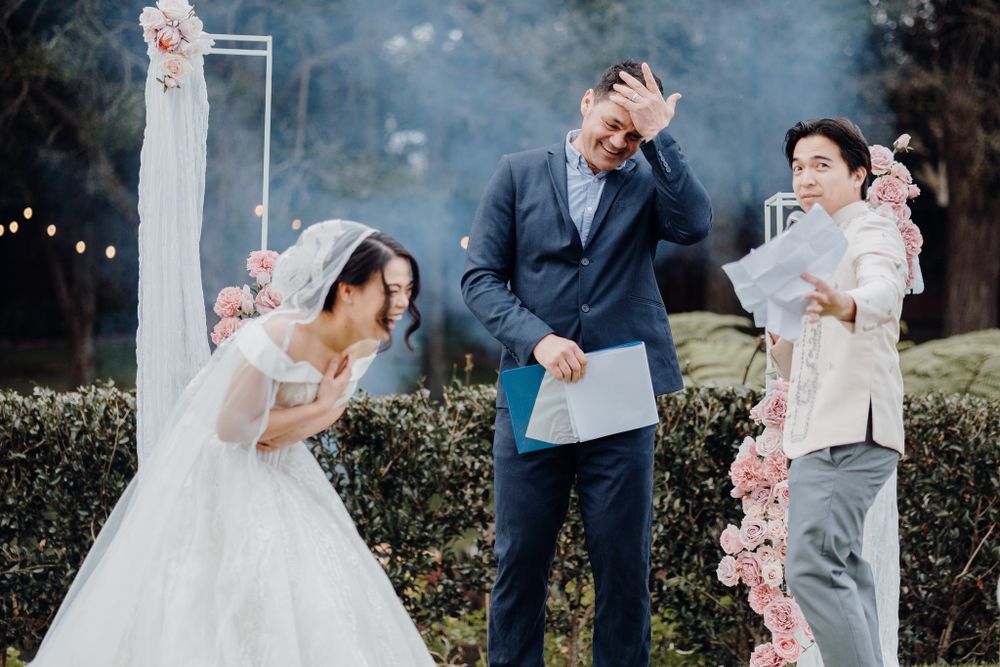 A joyful celebration with bubbles at an outdoor wedding ceremony with guests showing excitement.