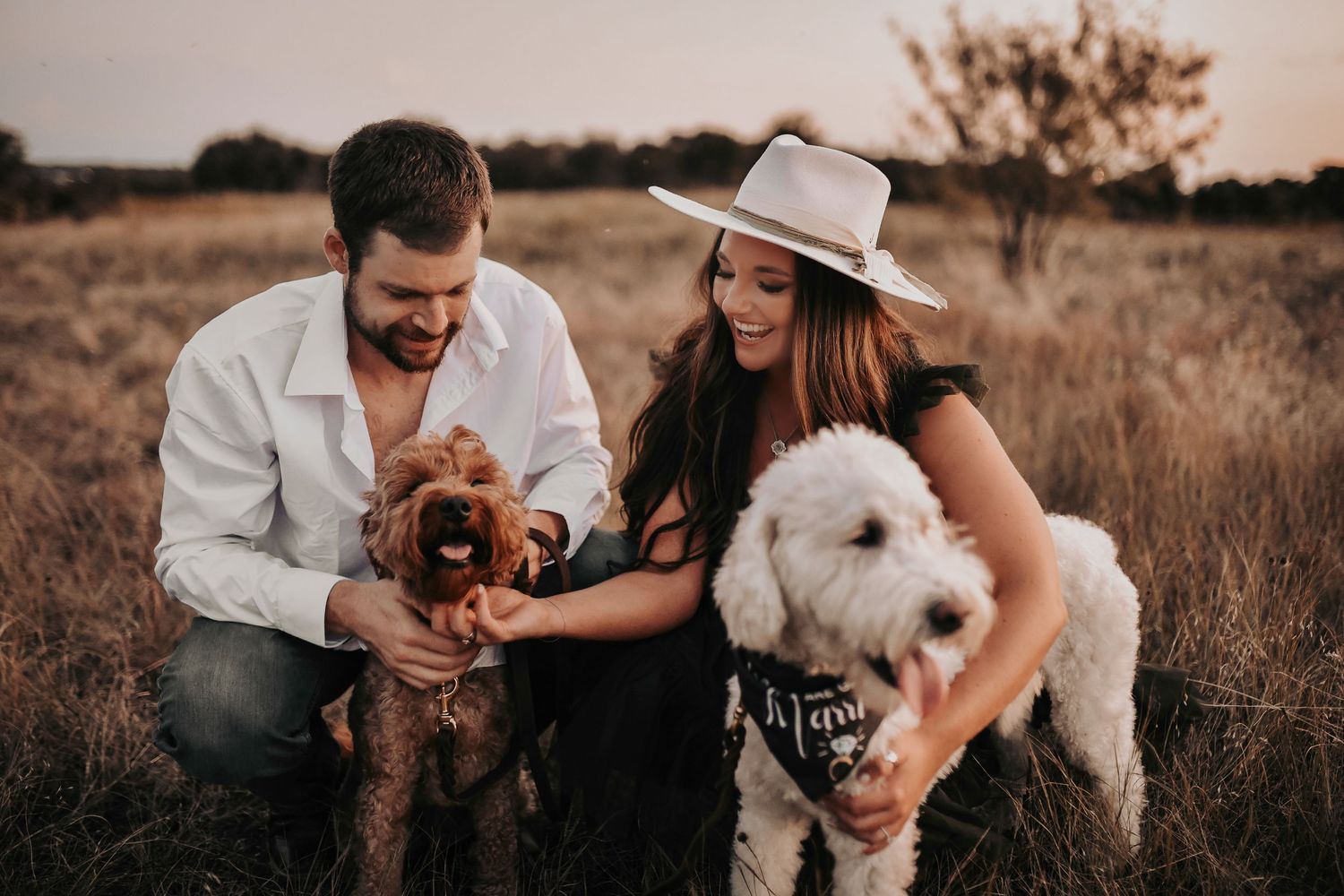 a happy and sweet engaged couple plays and snuggles with their fur babies during their engagement photos with april pinto photography