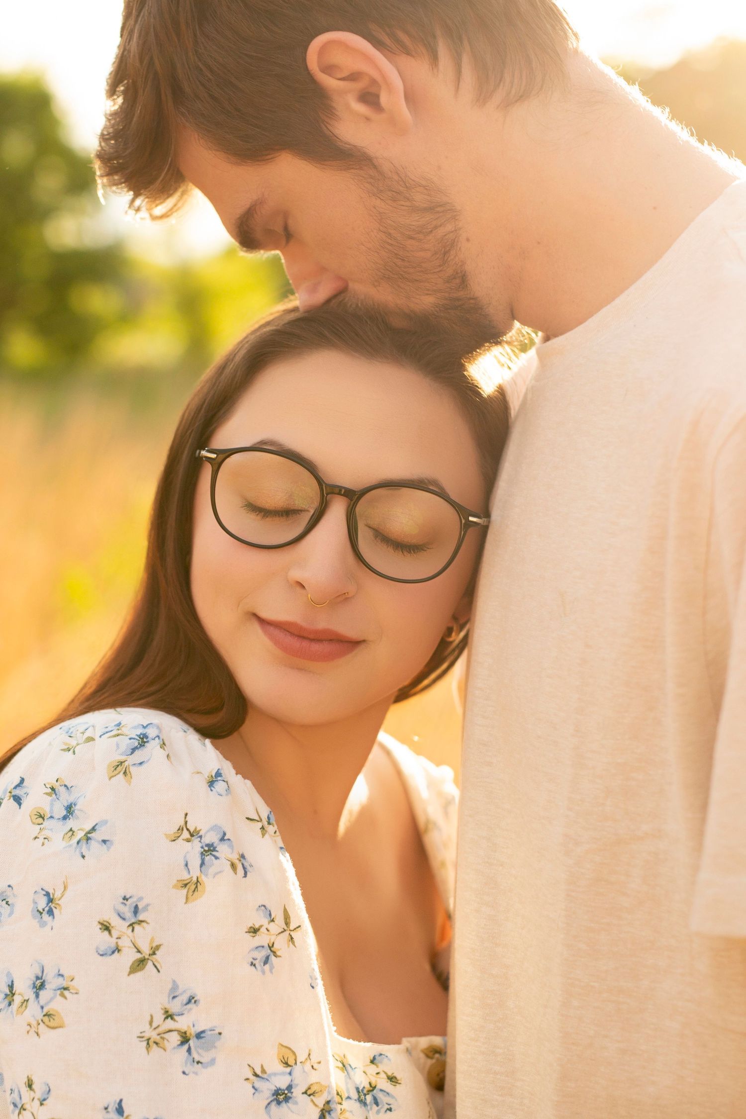 Romantic couple in glasses sharing tender moments at sunset through a series of intimate portrait photographs.
