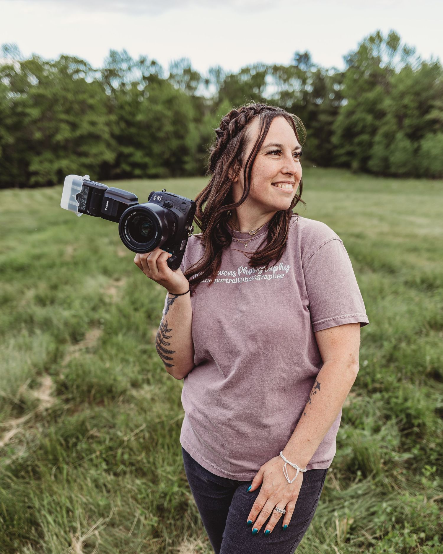 Professional branding image of a photographer with her camera