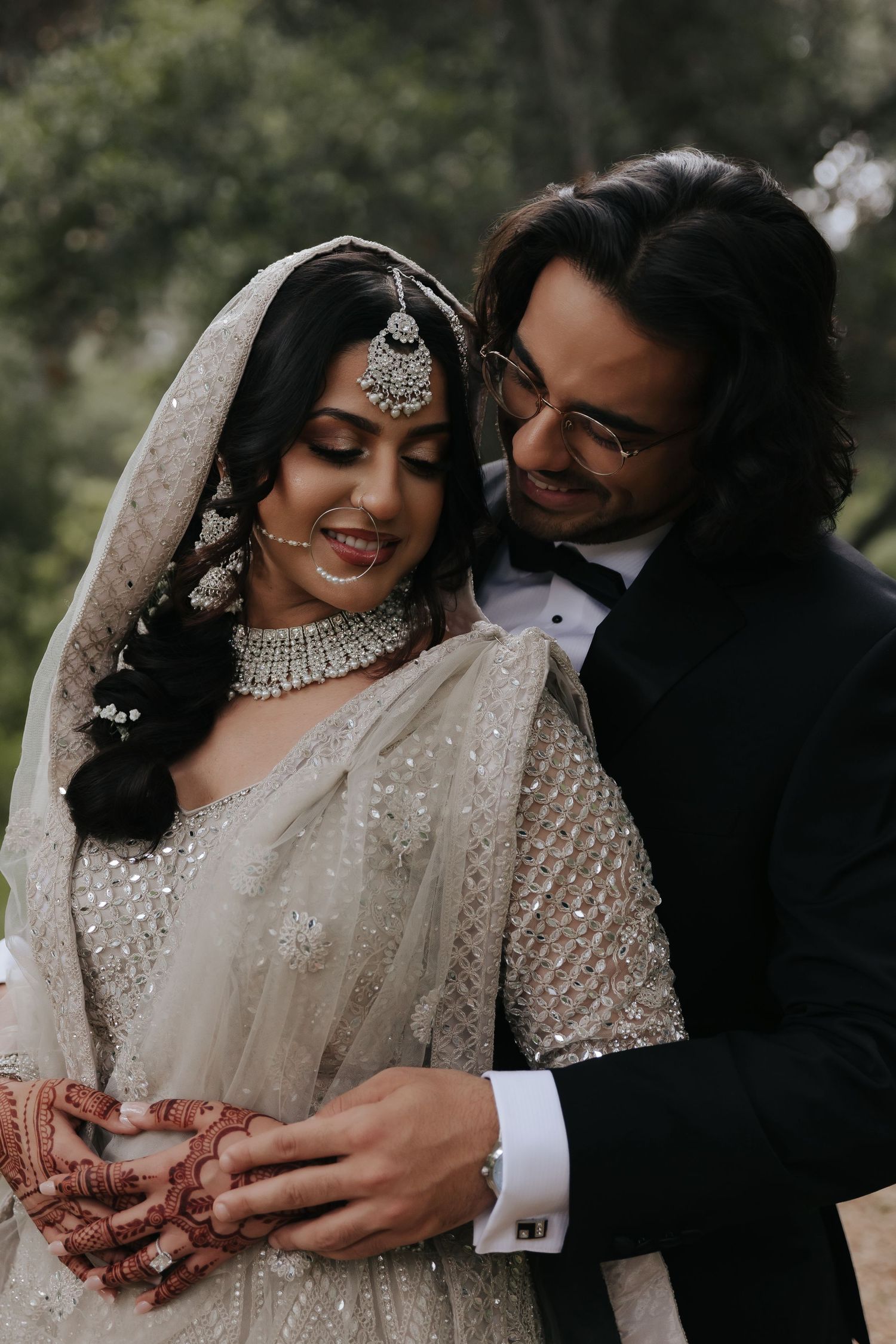Close up photos of couple adorned in traditional South Asian wedding attire showcasing intricate henna designs and jewelry.