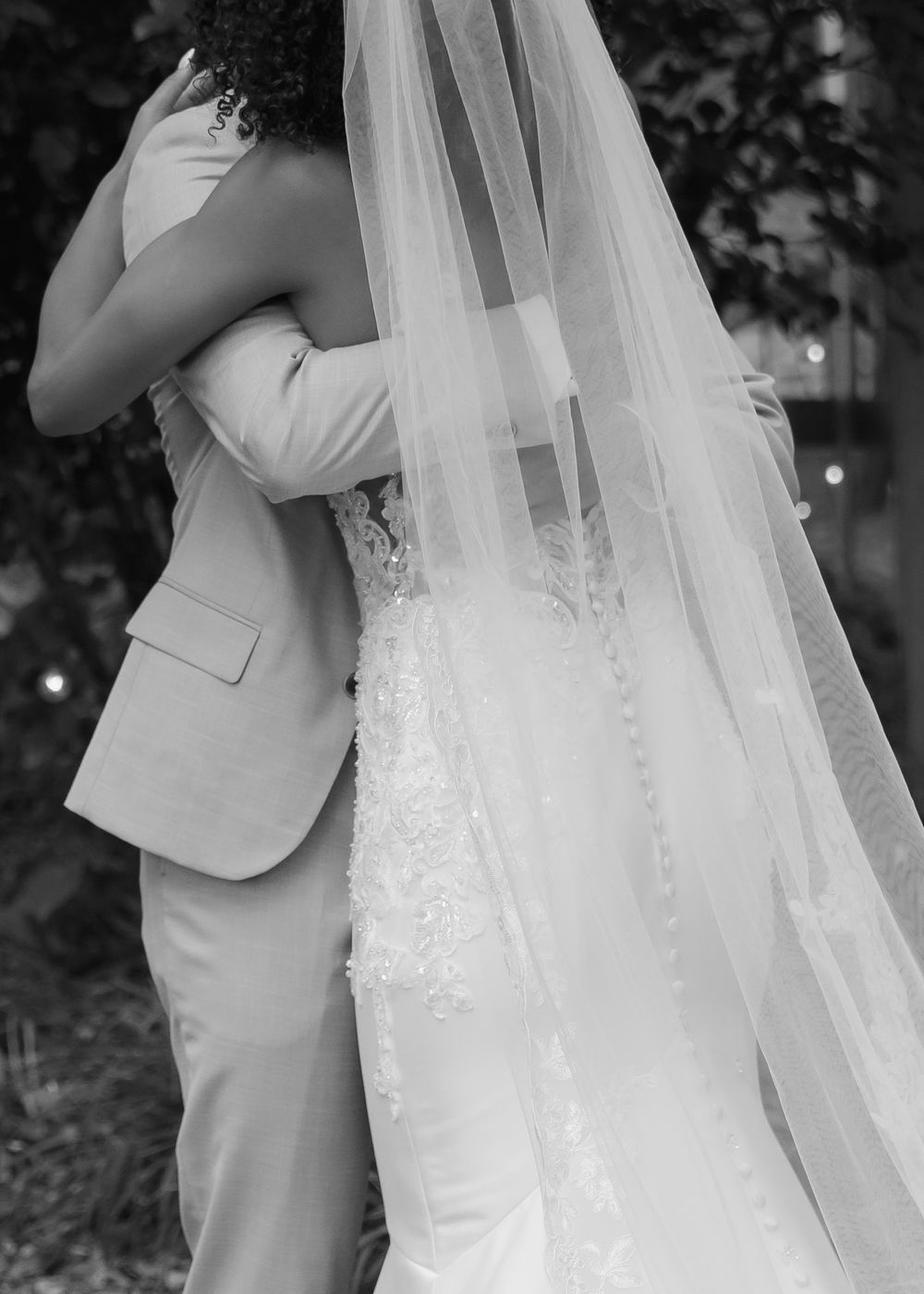 Black and white collage of wedding couple closeups showing intimate moments and flowing veil details during their first look.