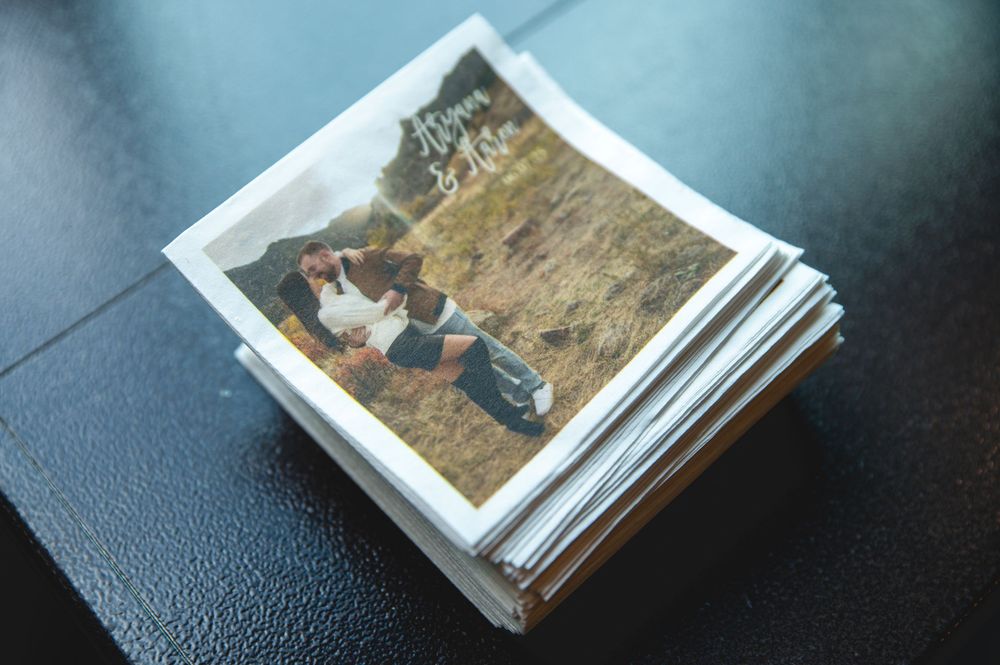 A stack of vintage photographs fanned out on a dark surface, showing memories from the past.