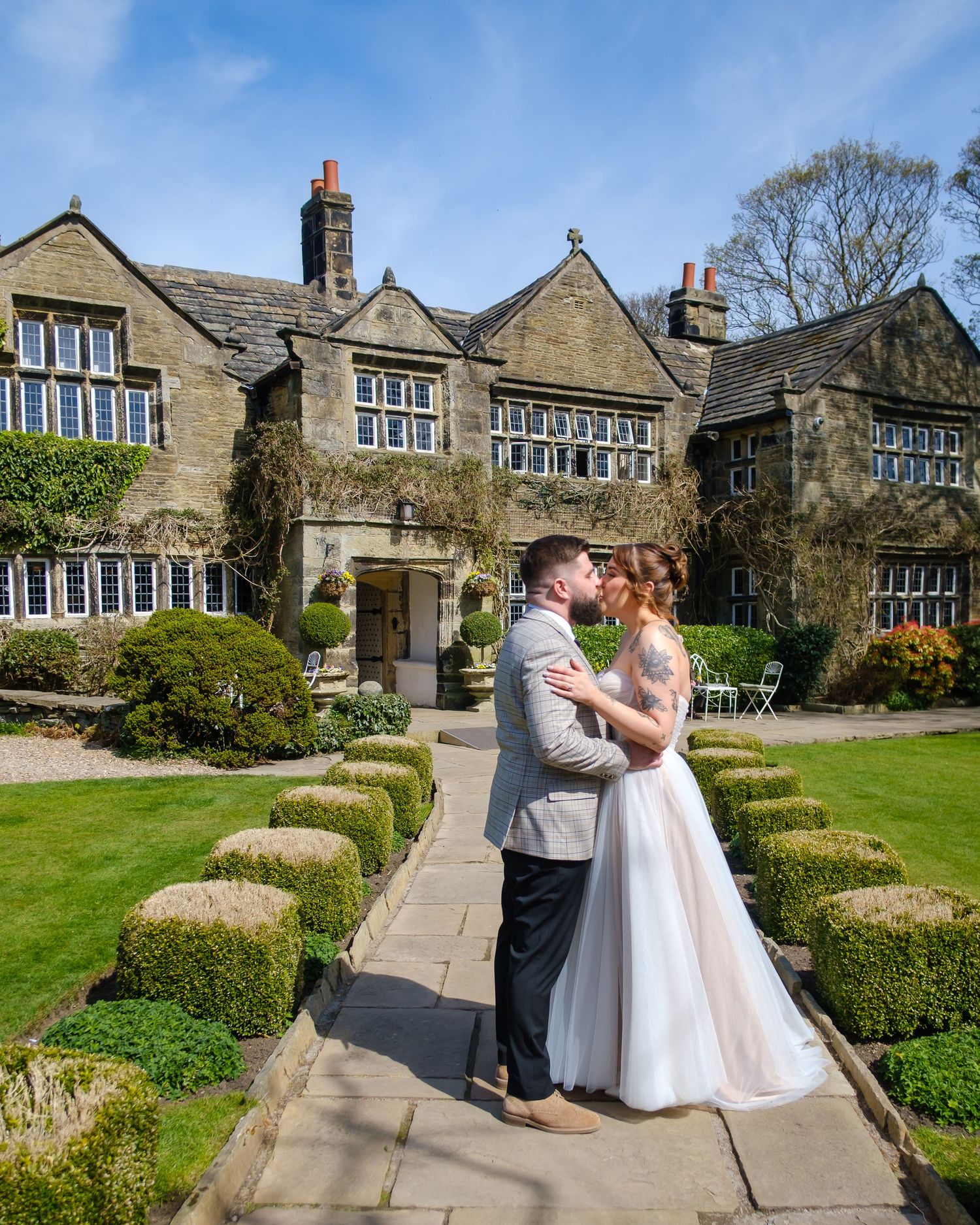 Alice and George in front of the Holdsworth House. The lovely stone front with mullion windows.
