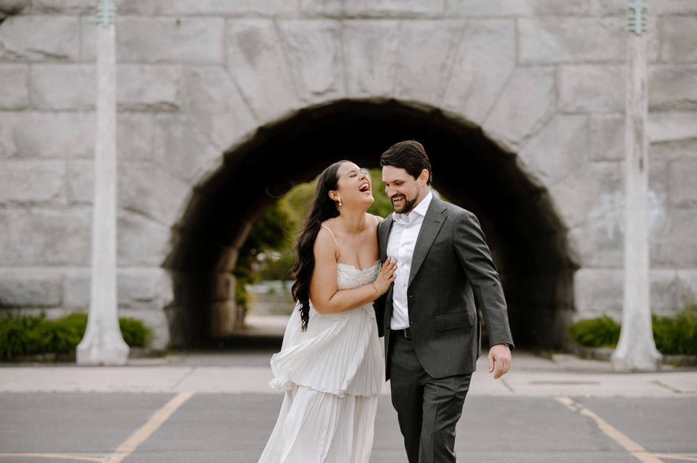 Wedding photography through multiple stone arched frames creating a tunnel effect.