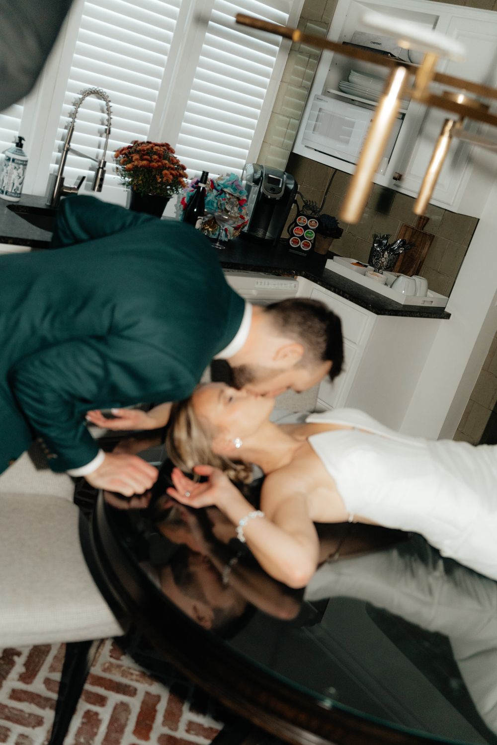 Intimate wedding day moment at a modern kitchen counter.