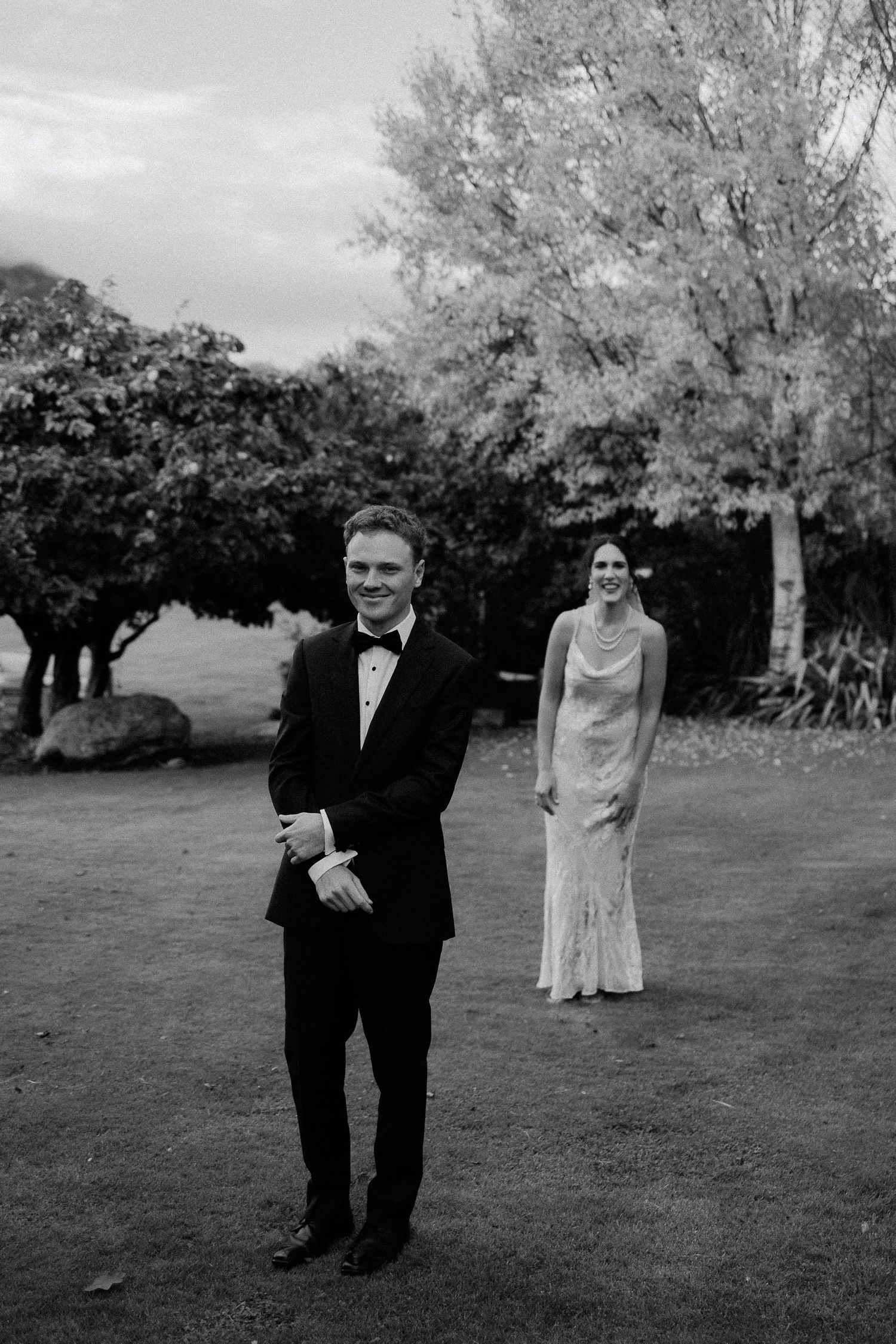 A tender black and white moment between newlyweds as they embrace during their outdoor wedding ceremony.