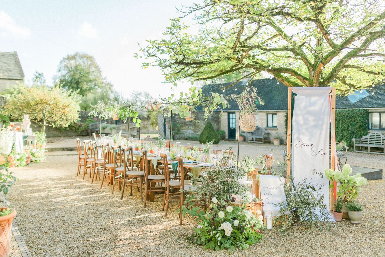 Garden pre wedding dinner setup with wooden chairs and floral arrangements at Merriscourt Oxfordshire Cotswolds Hayley Elizabeth