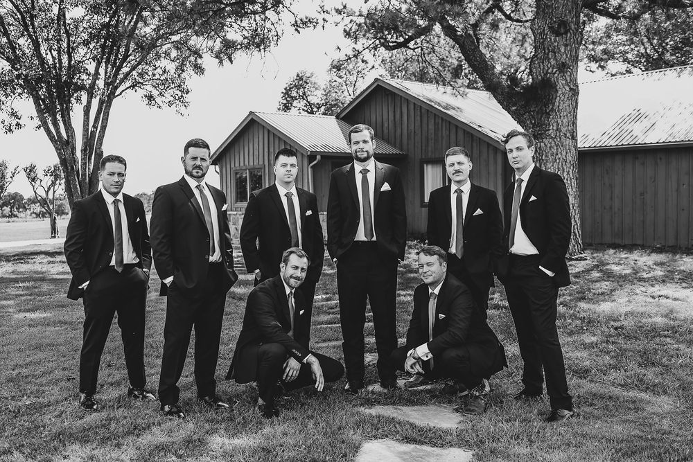 Groomsmen surrounding groom for a hype moment before the ceremony