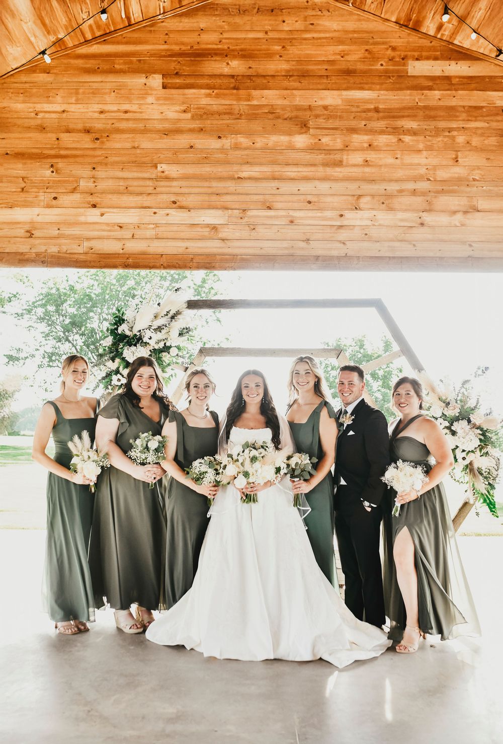 Bride and bridesmaids showing off their bouquets and boots