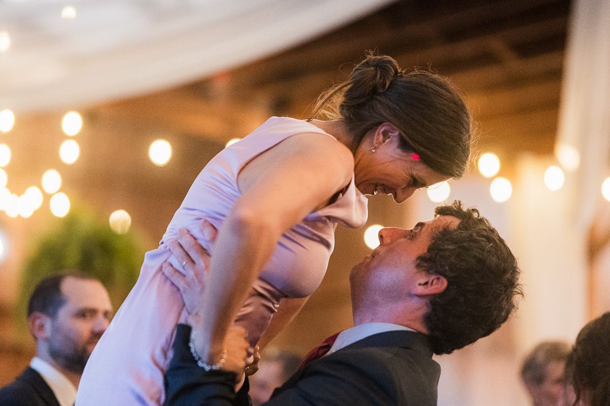 Two people share a romantic dance move during a wedding reception at shady elm farms photographed and video by eternal lens media