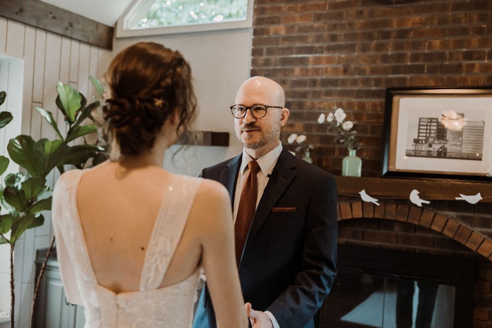 An emotional first look moment between bride and her dad through tears during a first look at their Kansas City Home.