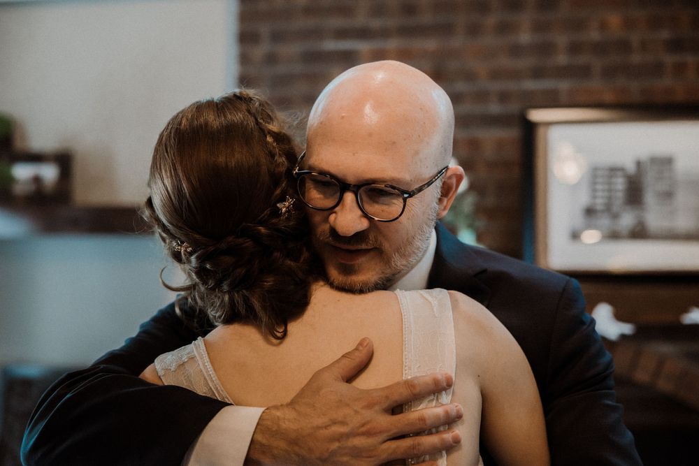 Bride shares a heartfelt hug with her father in a quiet moment before the ceremony — captured by Poemas Photo + Video.