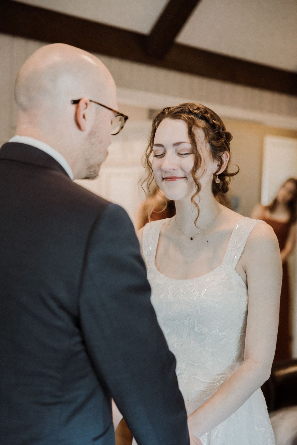 Father of the bride prays over his daughter before walking her down the aisle, captured in a tender Kansas City wedding photography moment.