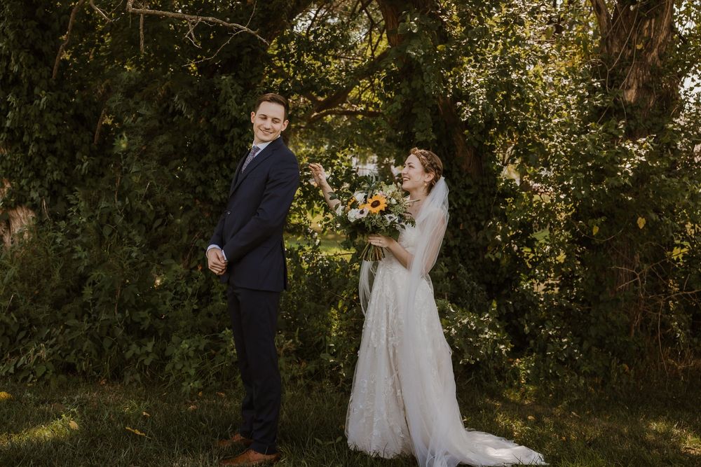Groom turns to see his bride for the first time during their first look at Meadowbrook Park — joy and emotion all over his face.