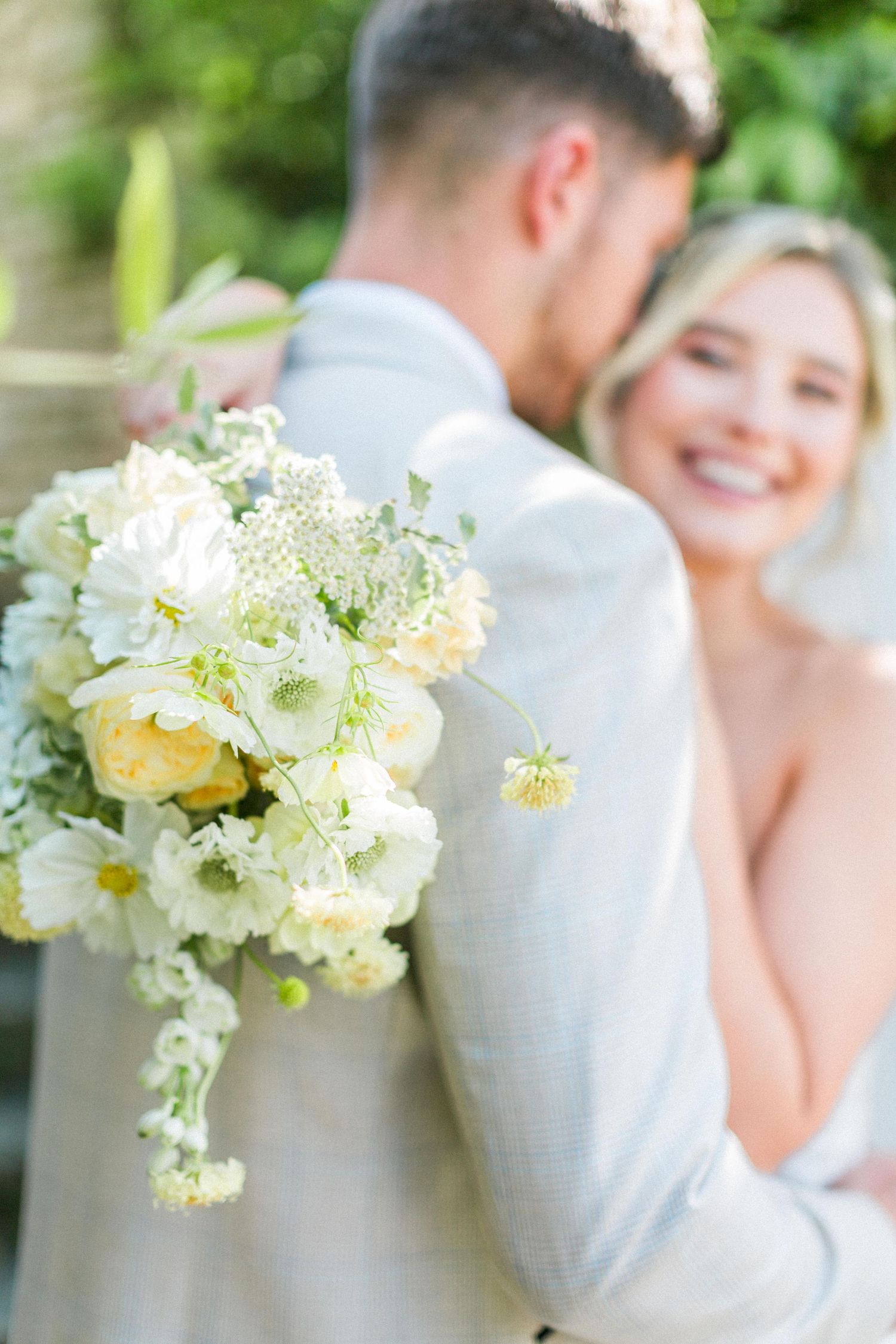 Beautiful wedding bouquet with white and pale yellow flowers at Euridge outdoor ceremony with bride and groom. Hayley Elizabeth Photography