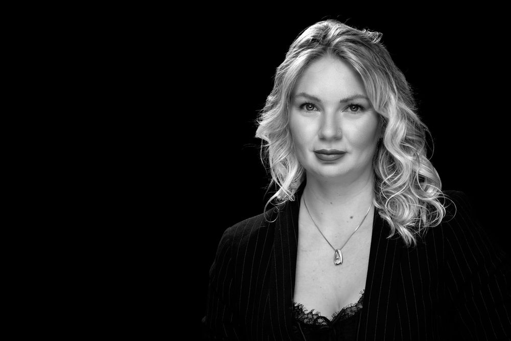 Contemporary fashion portrait featuring classic makeup and dramatic black backdrop.