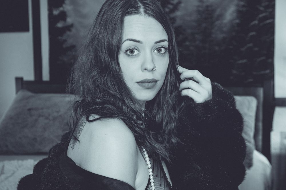 Black and white intimate portrait with moody lighting and soft focus.