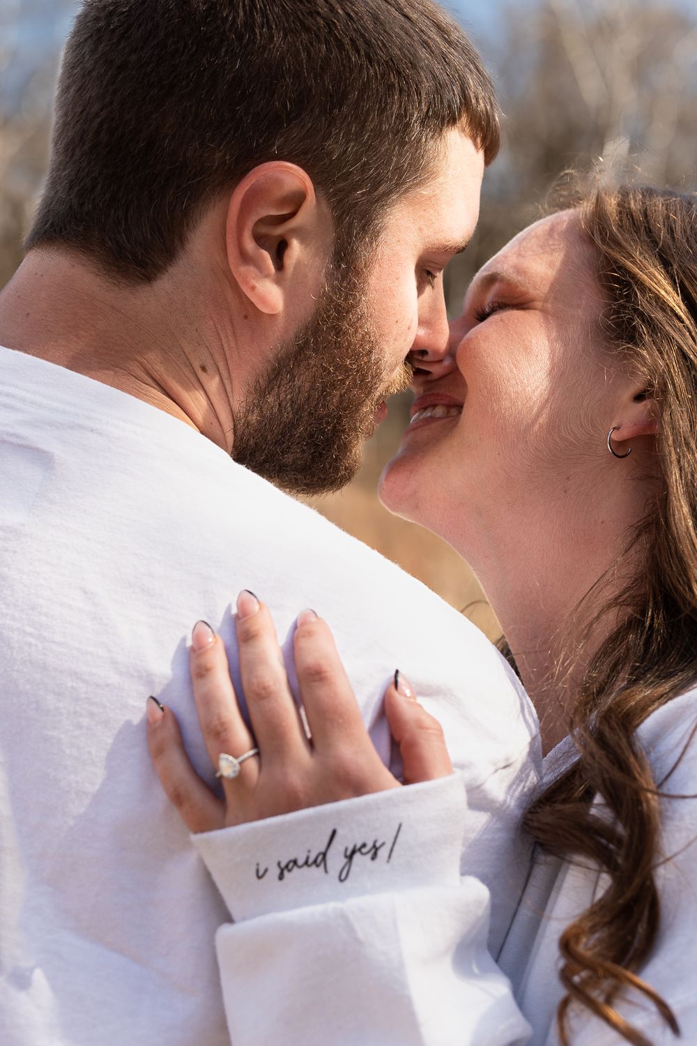 Close-up shot of couple sharing romantic moment with text visible on white sleeve.